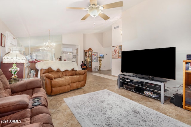 living room featuring ceiling fan with notable chandelier, light tile patterned floors, and vaulted ceiling