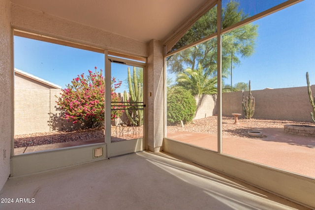 unfurnished sunroom with lofted ceiling