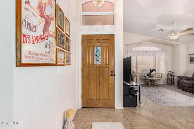 tiled foyer entrance with a wealth of natural light, ceiling fan, and vaulted ceiling