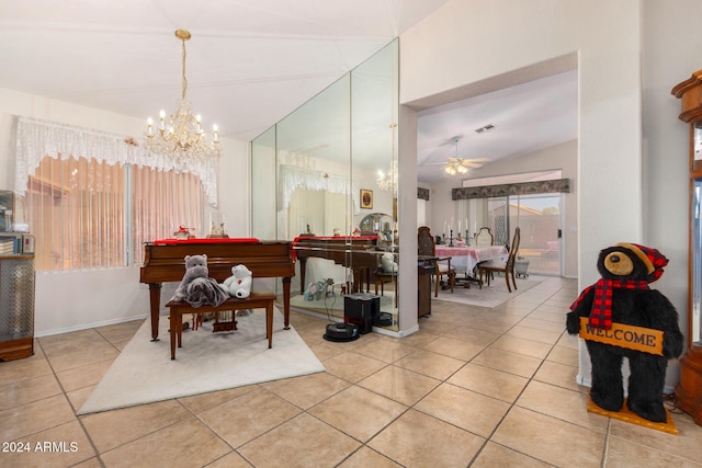 rec room featuring light tile patterned floors, ceiling fan with notable chandelier, and lofted ceiling