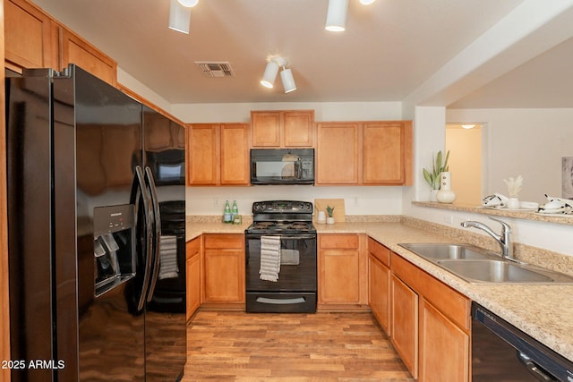 4642 E Sierrita Rd, San Tan Valley, AZ 85143 - kitchen featuring black appliances, a sink, light countertops, and light wood-style floors