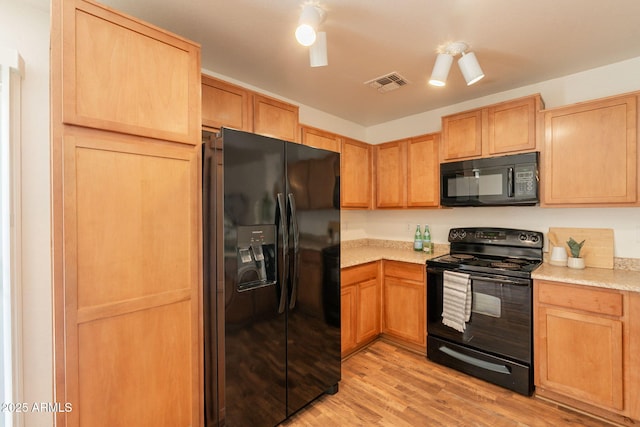 4642 E Sierrita Rd, San Tan Valley, AZ 85143 - kitchen with black appliances, light countertops, light wood-style flooring, and light brown cabinets