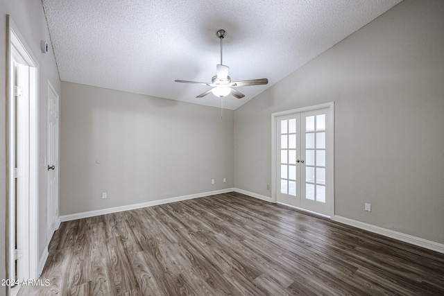 spare room featuring a textured ceiling, vaulted ceiling, french doors, hardwood / wood-style flooring, and ceiling fan