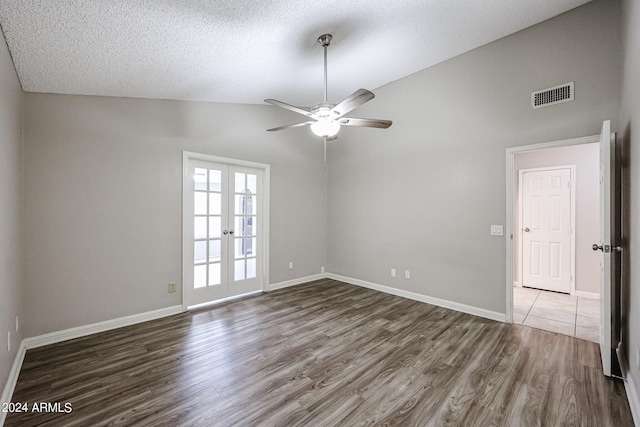 unfurnished room with ceiling fan, dark hardwood / wood-style floors, high vaulted ceiling, and french doors