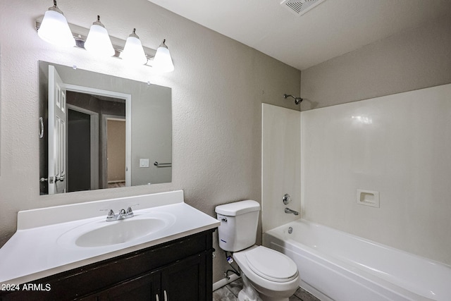 full bathroom featuring washtub / shower combination, toilet, and vanity