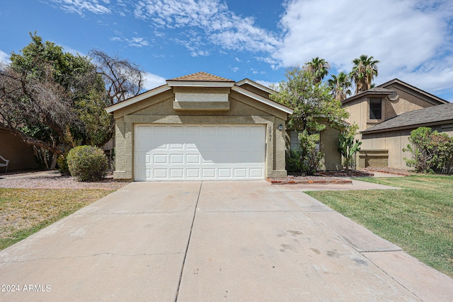 view of front of home with a garage and a front yard