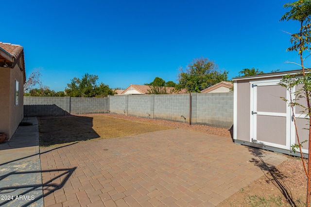 view of patio / terrace featuring a storage shed