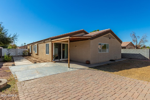 rear view of property featuring a patio area