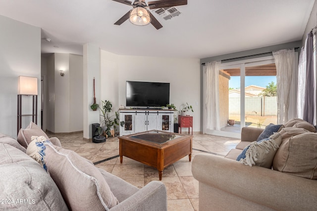 tiled living room featuring ceiling fan