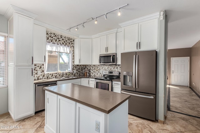 kitchen with white cabinetry, tasteful backsplash, stainless steel appliances, and a kitchen island