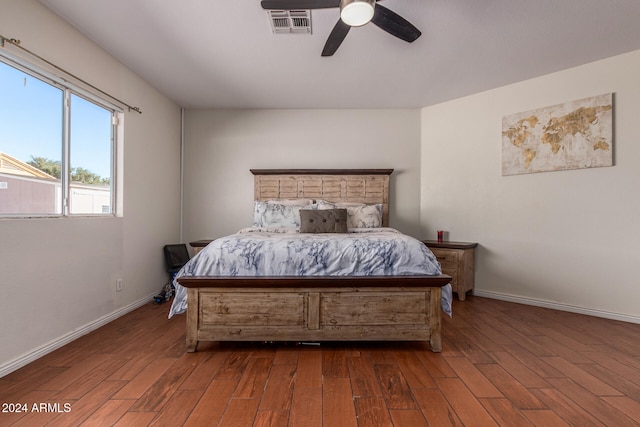 bedroom with dark hardwood / wood-style floors and ceiling fan