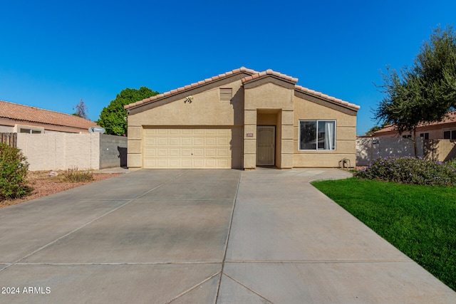 view of front of house with a front yard and a garage