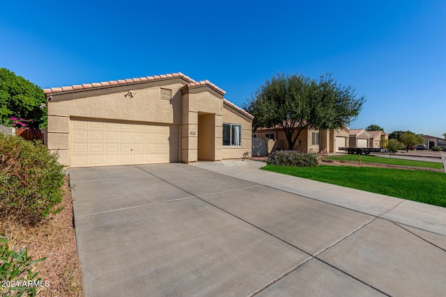 view of front of home with a front lawn and a garage