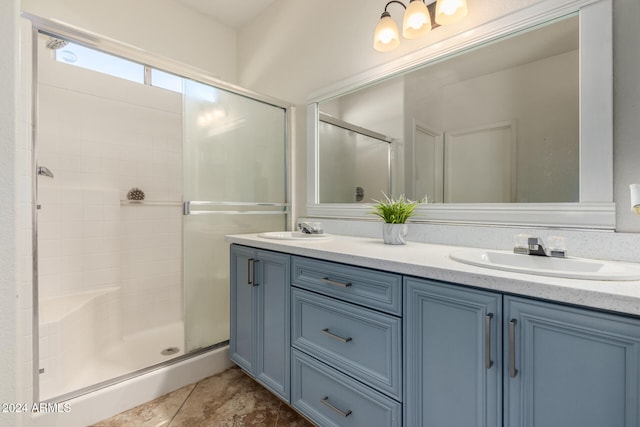 bathroom featuring vanity, an enclosed shower, and tile patterned flooring