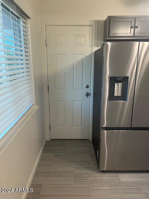 kitchen featuring stainless steel fridge with ice dispenser