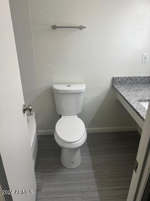 bathroom featuring toilet and vanity