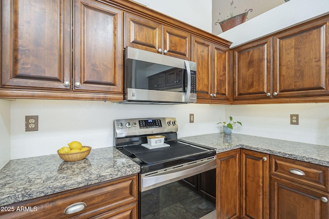 kitchen with light stone counters and stainless steel appliances