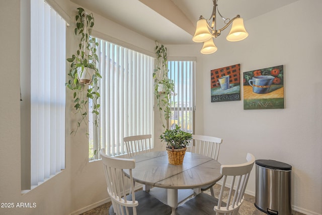 dining room with baseboards, an inviting chandelier, and plenty of natural light