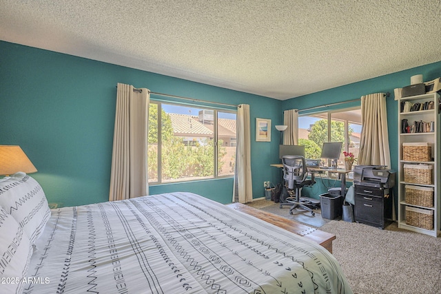 bedroom featuring multiple windows, carpet flooring, and a textured ceiling