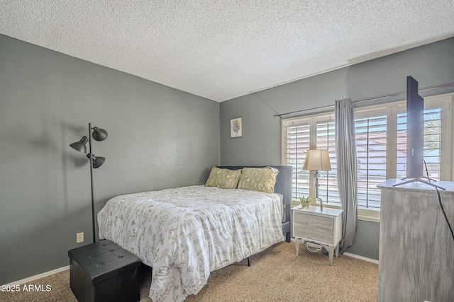 carpeted bedroom featuring baseboards, multiple windows, and a textured ceiling