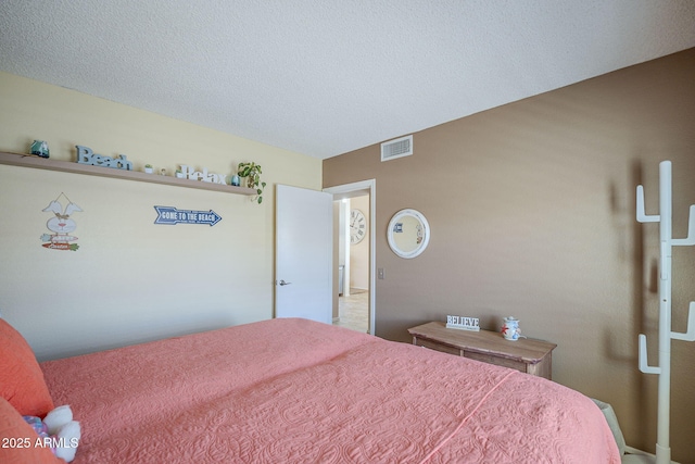 bedroom featuring a textured ceiling and visible vents