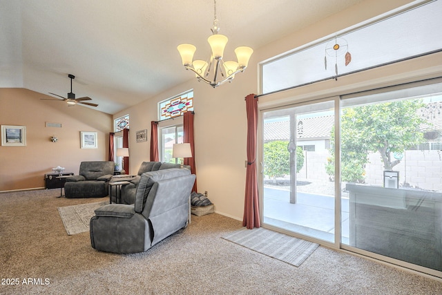 living room with plenty of natural light, carpet, and ceiling fan with notable chandelier