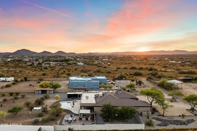 birds eye view of property with a mountain view and view of desert