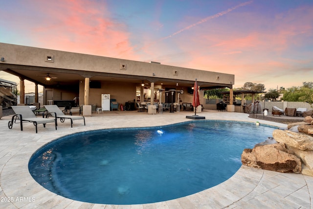 view of swimming pool featuring a fenced in pool, a patio, ceiling fan, and fence