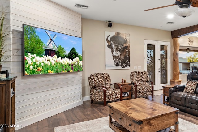 living room with a ceiling fan, visible vents, wood finished floors, and french doors