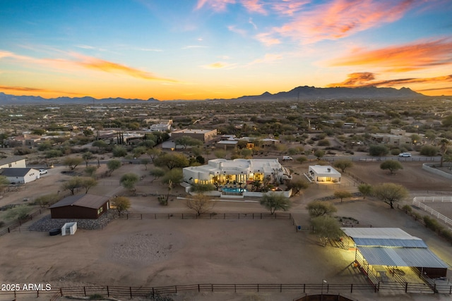 aerial view at dusk featuring a mountain view