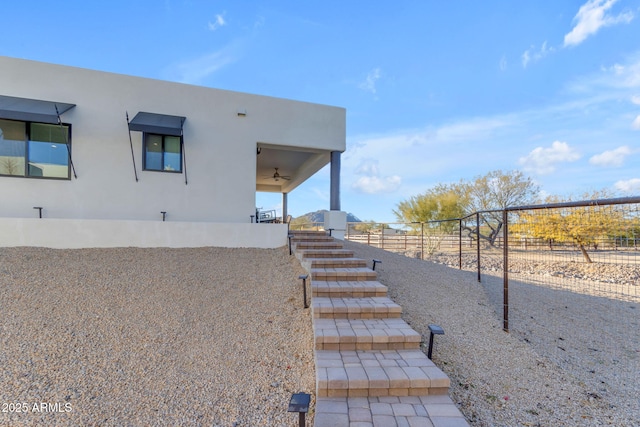 view of property exterior featuring ceiling fan