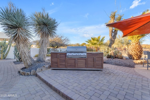 view of patio with area for grilling and exterior kitchen