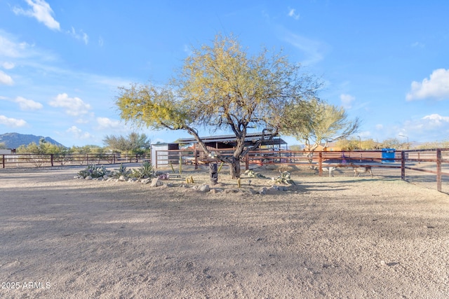 view of front of house featuring a mountain view and a rural view