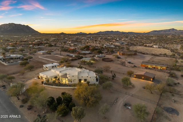 aerial view at dusk featuring a mountain view