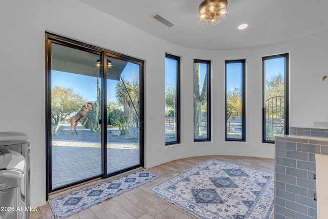 doorway to outside with light wood-type flooring