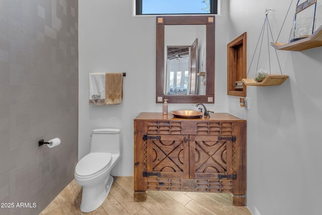 bathroom featuring vanity, hardwood / wood-style floors, and toilet