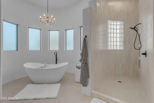 bathroom with tile patterned flooring, plus walk in shower, and an inviting chandelier