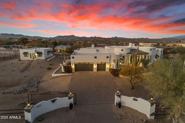 view of front of property with a garage and a mountain view