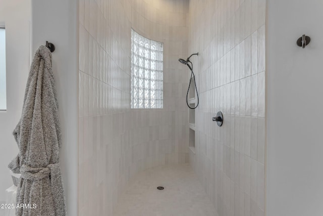 bathroom with tiled shower