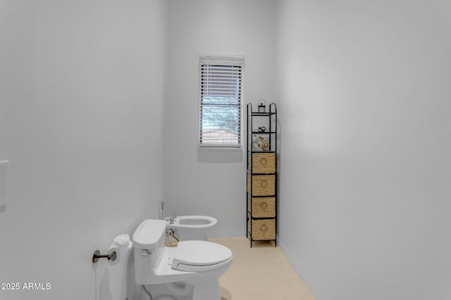 bathroom with a bidet and toilet