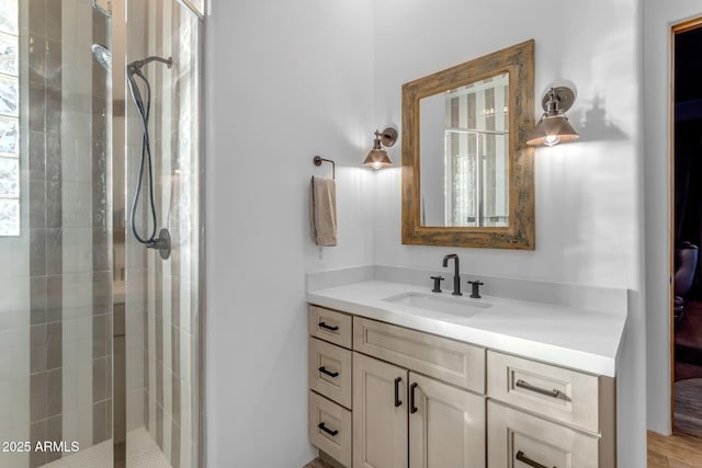 bathroom featuring vanity and a shower with door