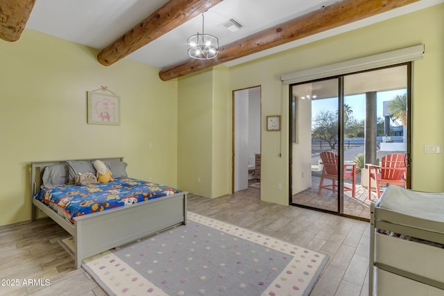 bedroom featuring beamed ceiling, access to exterior, and a chandelier