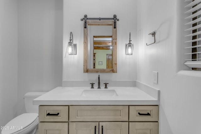 bathroom featuring vanity and toilet