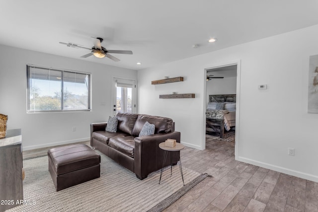 living room with ceiling fan and light hardwood / wood-style floors