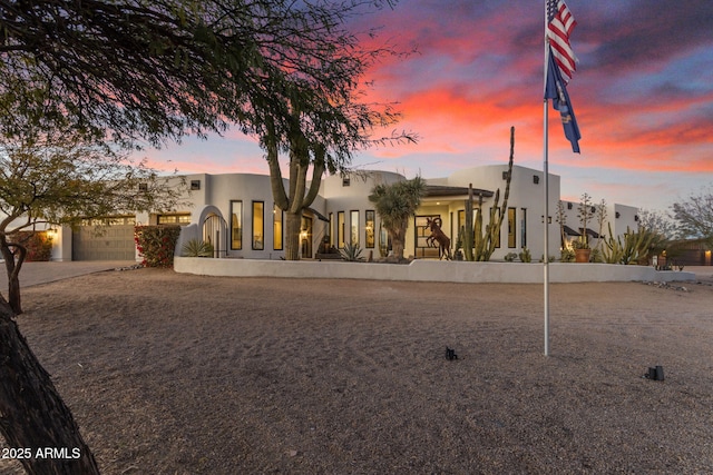 pueblo-style house with a garage