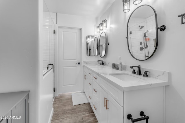 bathroom with vanity, hardwood / wood-style flooring, and walk in shower