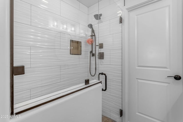 bathroom with a shower with door