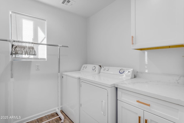 laundry area featuring cabinets and washing machine and dryer