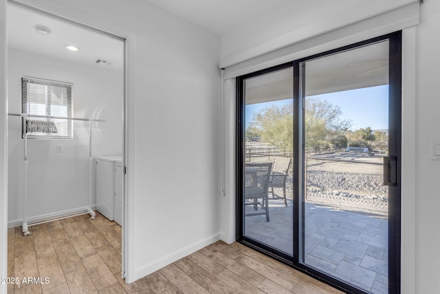 doorway featuring light hardwood / wood-style flooring and a healthy amount of sunlight