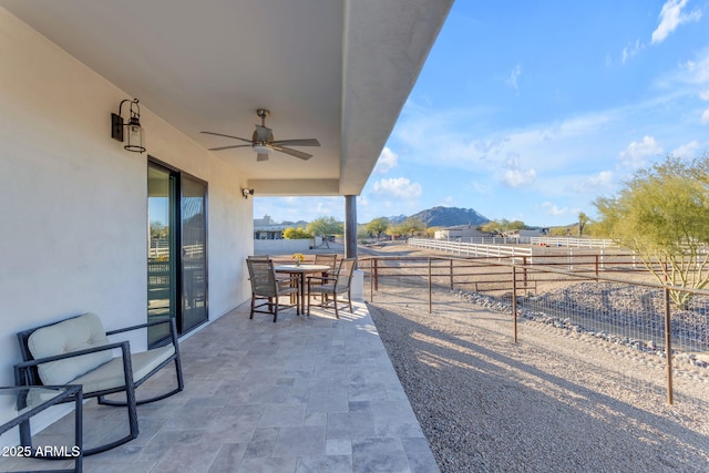 view of patio / terrace with a mountain view and ceiling fan